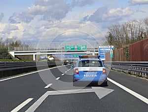 Italian police car patrolling runs fast on the freewat