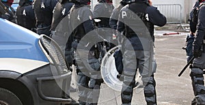Italian police officers in riot gear with the word POLIZIA meani