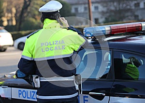 Italian police car and policeman with the text POLIZIA LOCALE th photo