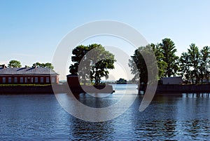 Italian pond with access to the Merchant Harbor. The building of the `Dutch kitchen` and trees at sunset.