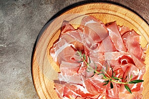 Italian prosciutto crudo or jamon with parsley. Raw ham