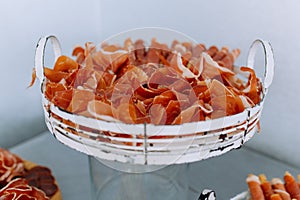 Italian prosciutto crudo or jamon with rosemary. Raw ham. Spanish jamon