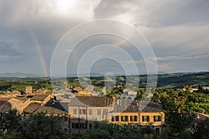 Italian rainy day with rainbow, big clouds