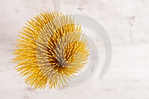 Italian raw long and thin pasta maded from flour and eggs on white background