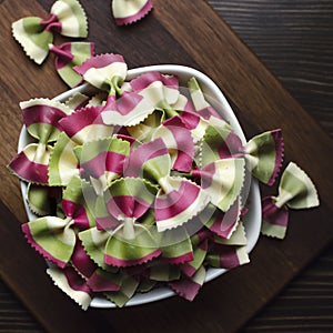 Italian raw multicolored farfalle pasta