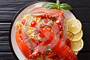 Italian recipe of spaghetti with boiled lobster, tomatoes, lemon