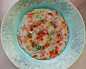 Italian red prawns  carpaccio in a green plate, shrimps known as gambero rosso photo