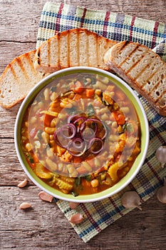 Italian ribollita vegetable soup close up in a bowl. vertical to