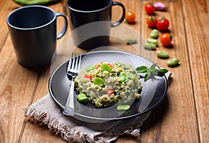 Italian risotto with broad beans, cherry tomato and mint - vegetarian food - Italian cuisine