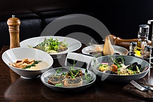 Italian risotto with roasted chicken, snacks on dark wooden table. Italian food table, top view