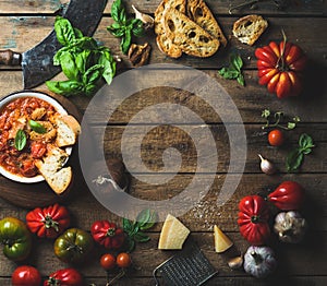 Italian roasted tomato and garlic soup with bread, basil, parmesan