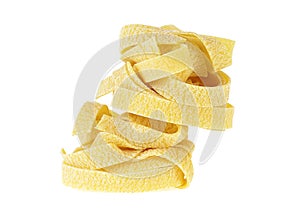 Italian rolled fresh fettuccine pasta isolated on white background. Pyramid