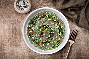 Italian Salad with Sauteed Agretti or barba di frati with garlic, Taggiasca olives photo