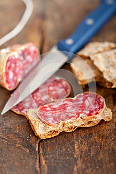Italian salame pressato pressed slicing photo