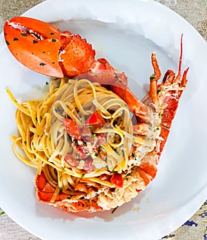 Italian seafood pasta - Spaghetti with big lobster. Close up. Calabrian restaurant