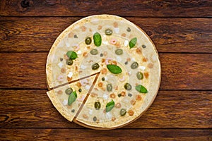 Italian seafood pizza top view at wooden background