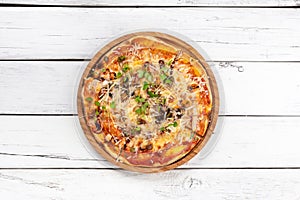 Italian seafood pizza on white wooden background. Top view