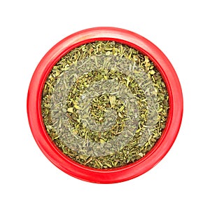 Italian seasoning in a red dish on white background