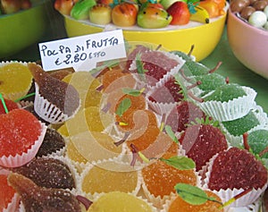 Italian shop window display of colorful fruit jelly candies, marzipan, other sweets.