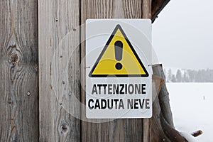Italian sign alerting to \'Attenzione Caduta Neve\', Snowfall risk warning photo
