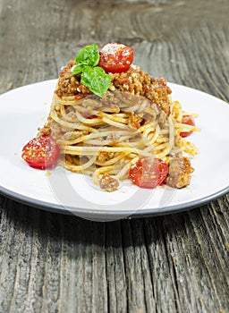 Italian spaghetti bolognese on wood background