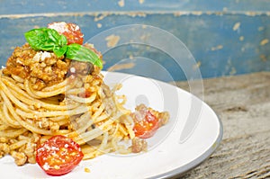 Italian spaghetti bolognese on wood background