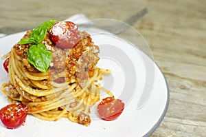 Italian spaghetti bolognese on wood background