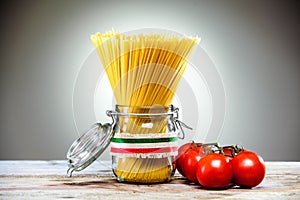 Italian spaghetti in a glass jar with tomatoes