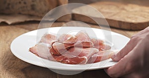 Italian speck ham on a plate put on table