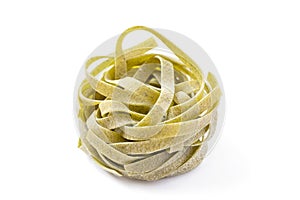 Italian spinach tagliatelle nests isolated.