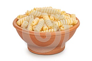 Italian spiral shaped pasta, Fusilli bucati macaroni in ceramic bowl, isolated on white background