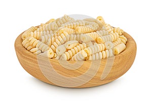 Italian spiral shaped pasta, Fusilli bucati macaroni in wooden bowl, isolated on white background