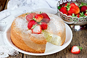 Italian sponge cake pan di spagna with strawberry on old wooden photo