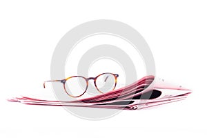 Italian sport newspapers and reading glasses isolated on white