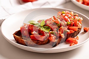 Italian starter bruschetta with fresh tomatoes, olive oil, garlic and basil