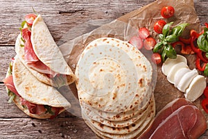 Italian street food: piadina with ham, cheese and vegetables clo