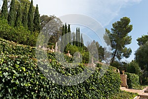 Italian style Mediterranean garden. Stone statues surrounded by vegetation. Mallorca, Spain.