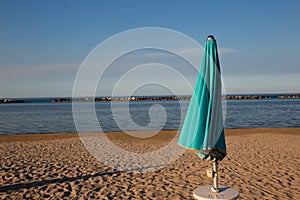 Italian summer on the Adriatic Sea: tyipical italian Riviera Romagnola beach clubs with sunbeds and beach umbrellas with typical