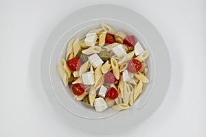 Italian Summer Salad Pasta Fredda. Fresh and healthy summer salad on white background. Top view