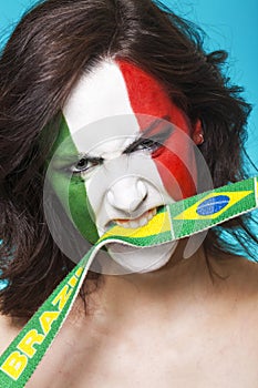 Italian supporter for FIFA 2014 biting Brazil flag