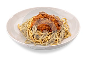 Italian tagliolini noodles topped with tomato and meat sauce white plate