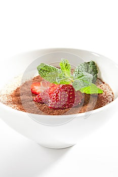 Italian Tiramisu Dessert with Green Fresh Mint and Sliced Strawberries