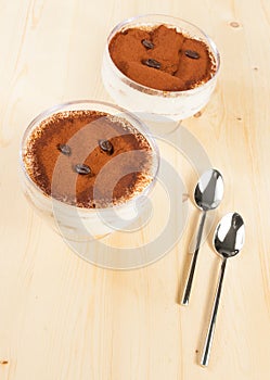 Italian tiramisu dessert served in a cup near spoons