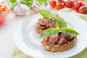 Italian tomato bruschetta with chopped vegetables, herbs and oil