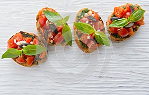 Italian tomato bruschetta with chopped vegetables, herbs and oil