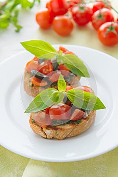 Italian tomato bruschetta with chopped vegetables, herbs and oil
