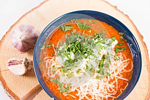 Italian tomato soup served with cream, mozzarella cheese and fresh parsley