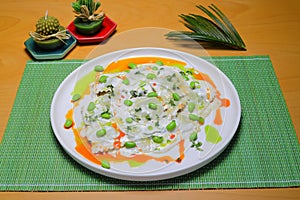 Italian tortellini pasta in cream sauce.with spinach. White wooden background. Top view