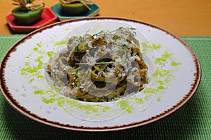 Italian tortellini pasta in cream sauce.with spinach. White wooden background. Top view