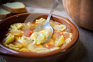 Italian traditional food called tortellini in brodo with bread photo